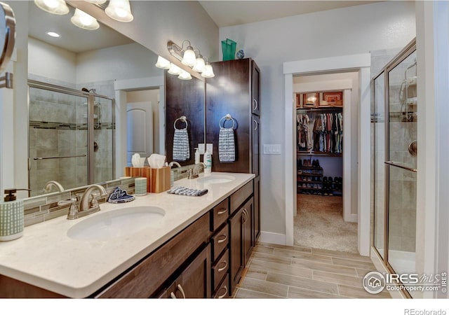 2449 Trio Falls Dr, Loveland, CO 80538 - full bath with a sink, a walk in closet, a shower stall, and double vanity
