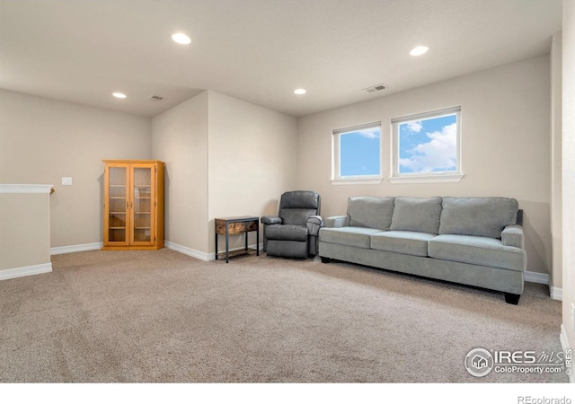 living room featuring carpet floors, baseboards, and visible vents
