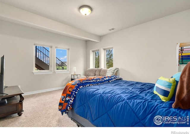 bedroom featuring baseboards, carpet flooring, and visible vents