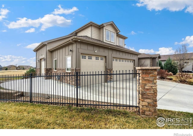 bungalow-style home featuring fence, stone siding, board and batten siding, an attached garage, and driveway