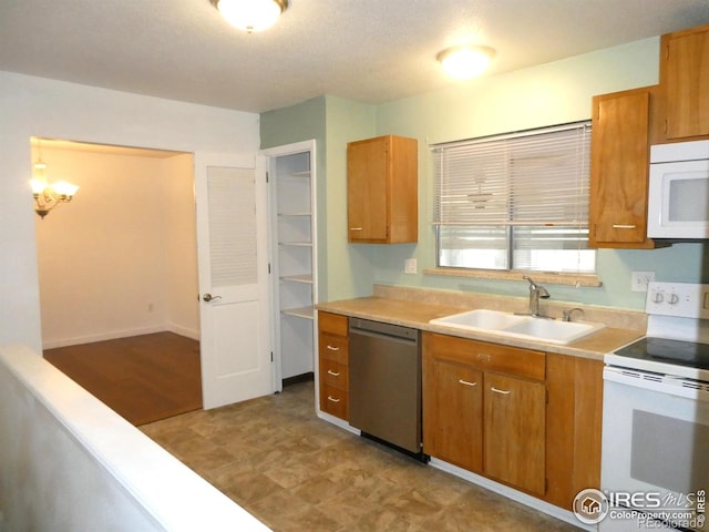 kitchen with brown cabinetry, white appliances, light countertops, and a sink