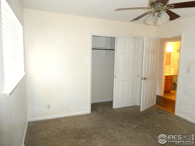 unfurnished bedroom with carpet flooring, a closet, baseboards, and a ceiling fan