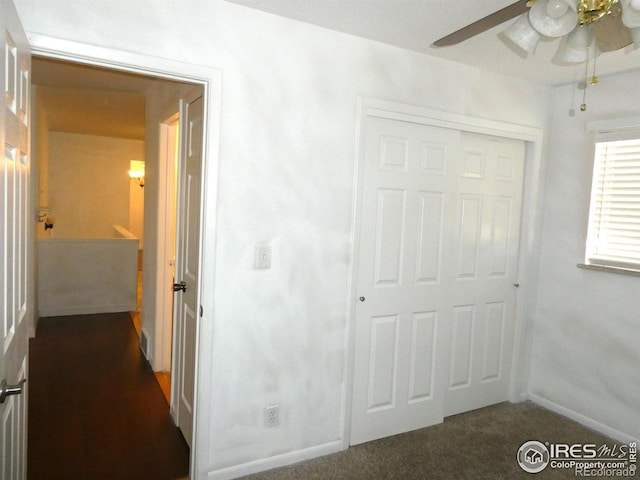 unfurnished bedroom with a closet, baseboards, and ceiling fan
