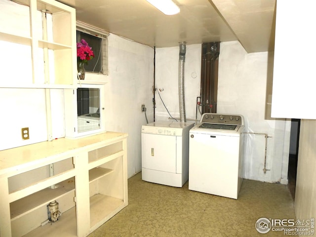 washroom with independent washer and dryer, laundry area, and light floors