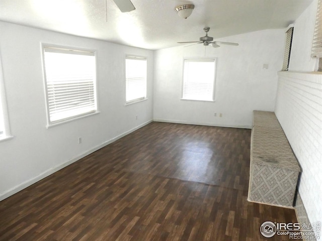 unfurnished living room featuring ceiling fan, wood finished floors, and baseboards