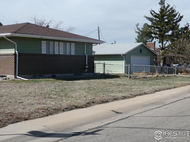 view of side of home with a garage, crawl space, fence, and a lawn