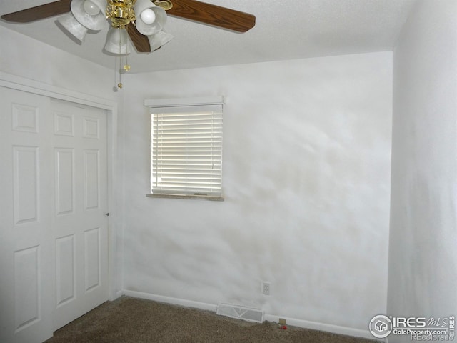 unfurnished bedroom featuring visible vents, baseboards, a ceiling fan, and carpet flooring