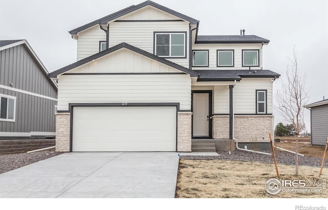 1219 105th Avenue Ct, Greeley, CO 80634 - view of front of home featuring stone siding, board and batten siding, concrete driveway, and roof with shingles