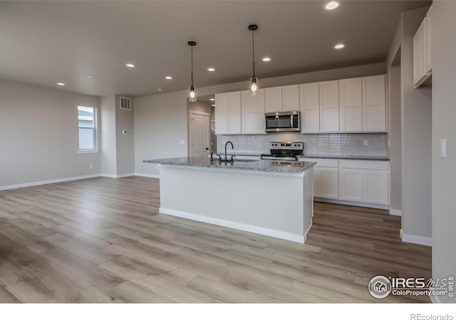1219 105th Avenue Ct, Greeley, CO 80634 - kitchen featuring decorative backsplash, a sink, appliances with stainless steel finishes, and visible vents