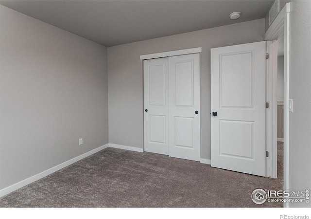 1219 105th Avenue Ct, Greeley, CO 80634 - unfurnished bedroom featuring baseboards, a closet, and carpet