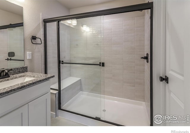 1219 105th Avenue Ct, Greeley, CO 80634 - full bathroom with a stall shower, a textured wall, and vanity