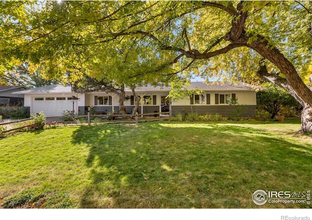 ranch-style home featuring driveway, a garage, and a front lawn