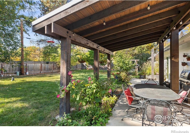 view of patio featuring fence and outdoor dining area