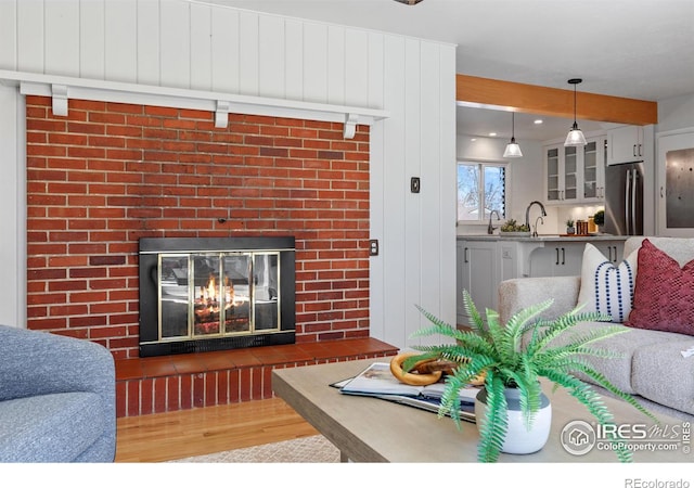 living room with a fireplace and wood finished floors