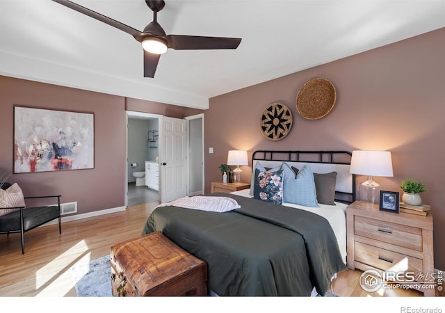 bedroom with a ceiling fan, ensuite bath, baseboards, visible vents, and light wood-style floors
