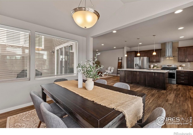 dining area featuring baseboards, lofted ceiling, recessed lighting, and dark wood finished floors
