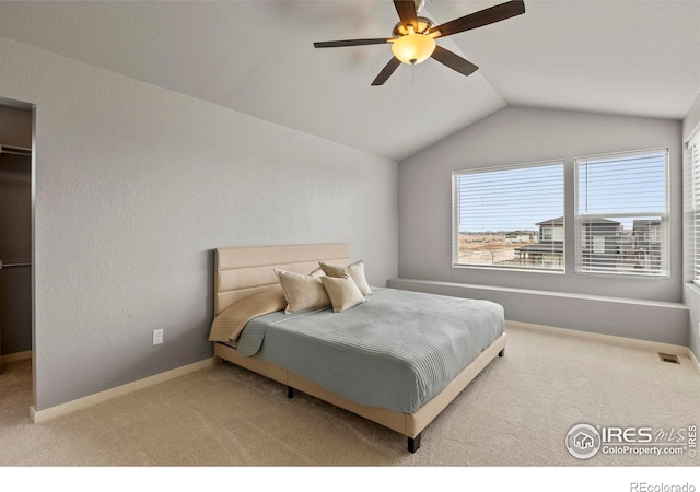 bedroom with vaulted ceiling, carpet floors, a ceiling fan, baseboards, and visible vents