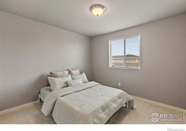 bedroom featuring baseboards and carpet flooring