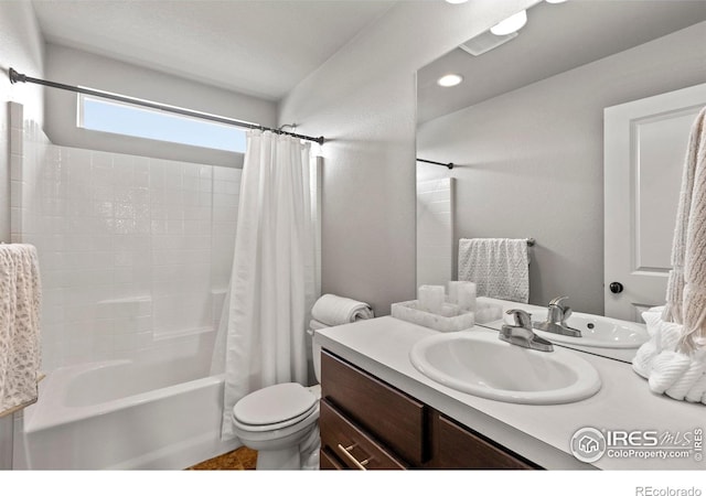 full bath with toilet, vanity, and shower / bath combo