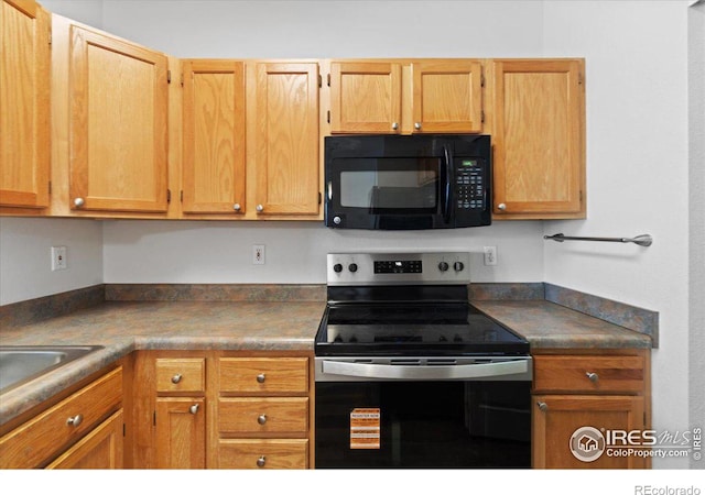 4545 Wheaton Dr Unit 310, Fort Collins, CO 80525 - kitchen featuring a sink, black microwave, dark countertops, and stainless steel electric stove