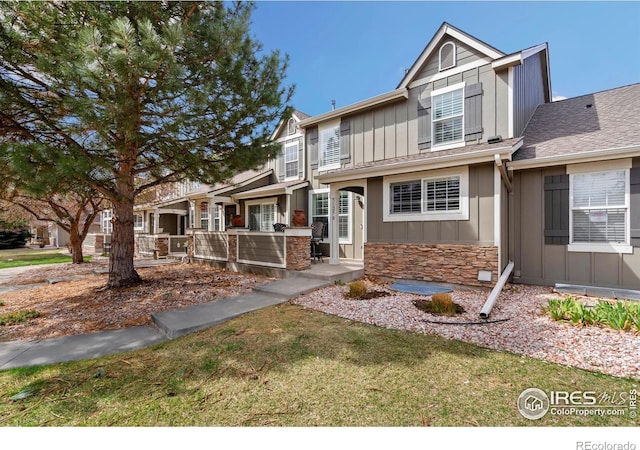 5125 Stetson Creek Ct Unit D, Fort Collins, CO 80528 - view of front of house featuring board and batten siding, stone siding, and a front yard