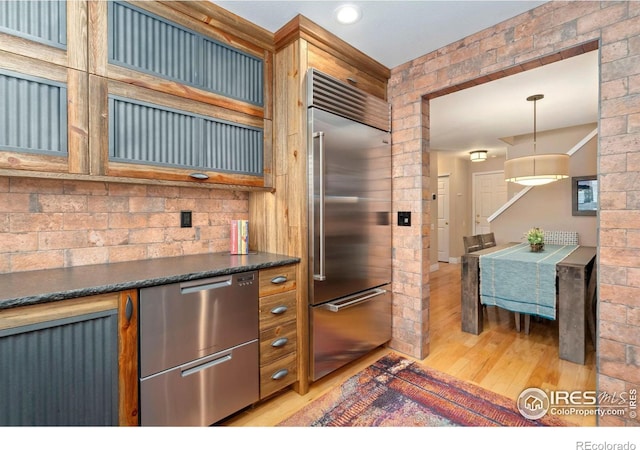 5125 Stetson Creek Ct Unit D, Fort Collins, CO 80528 - kitchen with stainless steel appliances, light wood finished floors, dark countertops, decorative light fixtures, and recessed lighting