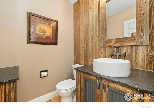 5125 Stetson Creek Ct Unit D, Fort Collins, CO 80528 - half bath with vanity, toilet, baseboards, and wood finished floors