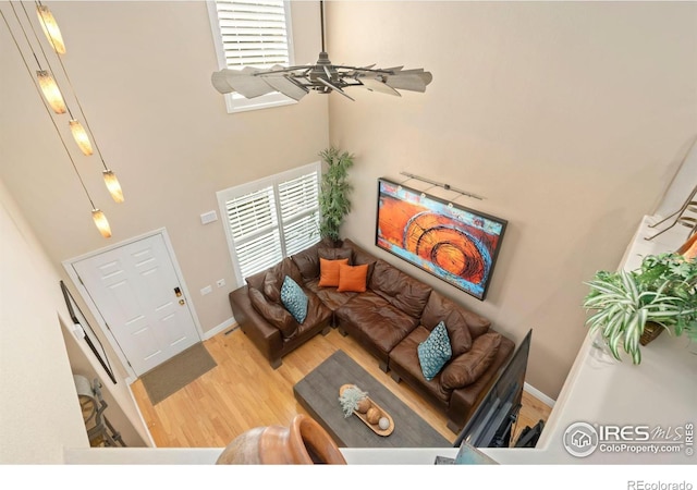 5125 Stetson Creek Ct Unit D, Fort Collins, CO 80528 - living area featuring wood finished floors, a high ceiling, and baseboards