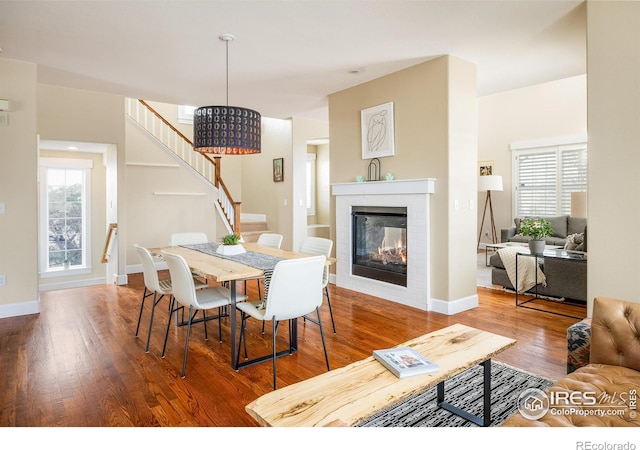 301 Indian Peaks Trl W, Lafayette, CO 80026 - dining area featuring baseboards, plenty of natural light, wood finished floors, and stairway