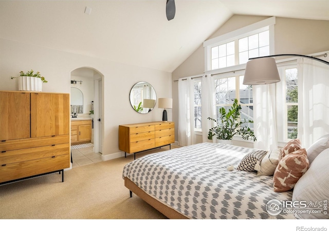 301 Indian Peaks Trl W, Lafayette, CO 80026 - bedroom with arched walkways, connected bathroom, light carpet, and multiple windows