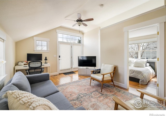 301 Indian Peaks Trl W, Lafayette, CO 80026 - living area with wood-type flooring, a ceiling fan, baseboards, and lofted ceiling