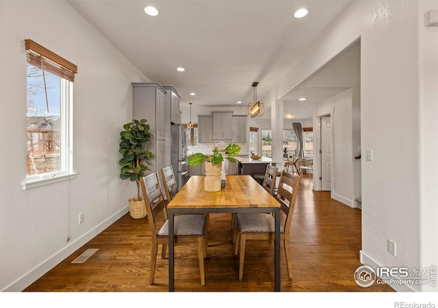 dining room featuring dark wood-style flooring, baseboards, visible vents, and recessed lighting