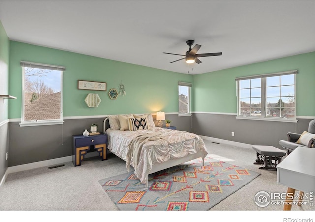 bedroom featuring ceiling fan, visible vents, baseboards, and carpet floors