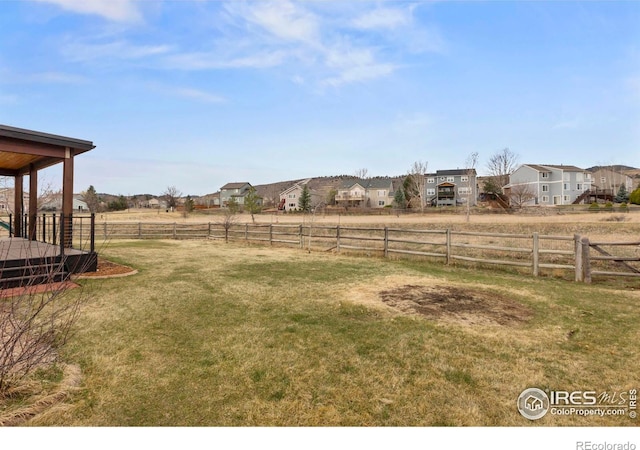 view of yard with fence and a residential view