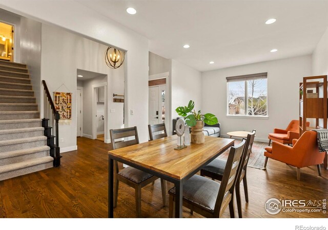 dining room featuring recessed lighting, a chandelier, stairway, wood finished floors, and baseboards