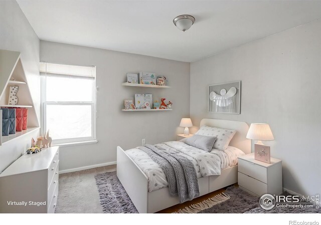 bedroom featuring carpet flooring and baseboards