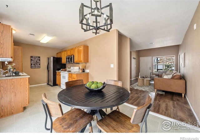 dining space with a chandelier, baseboards, and visible vents