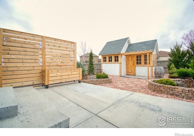 exterior space with an outdoor structure and fence