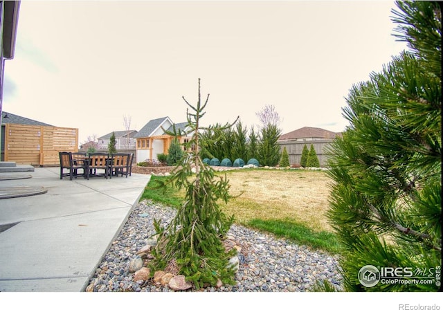 view of yard featuring fence and a patio area