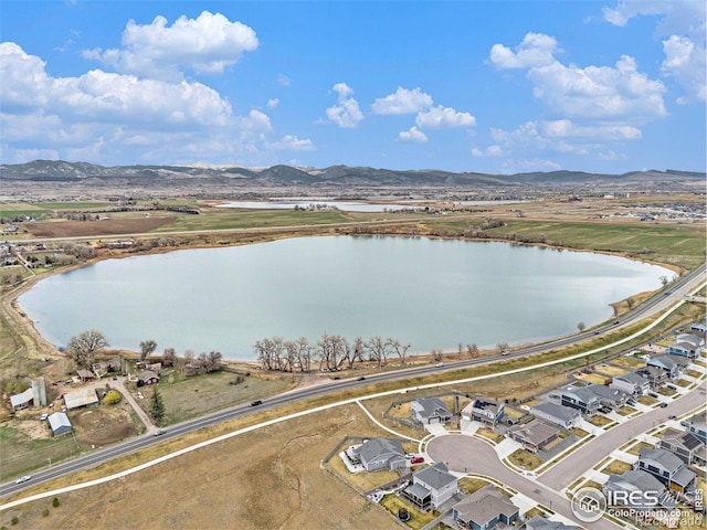 bird's eye view featuring a water and mountain view