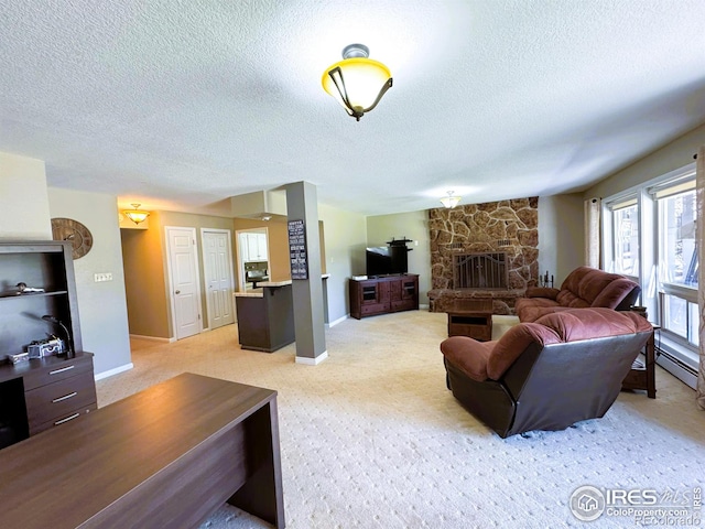 living room with light carpet, a fireplace, and a textured ceiling