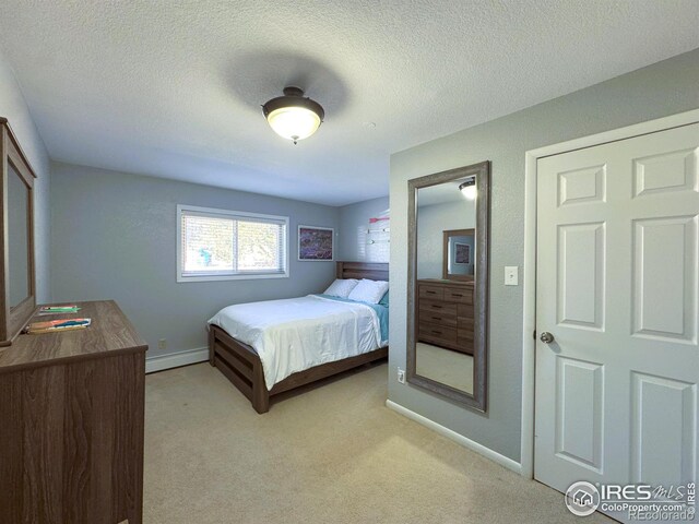 bedroom featuring a textured ceiling, a baseboard radiator, baseboards, and light carpet
