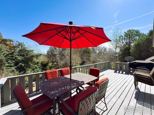 wooden terrace featuring outdoor dining area