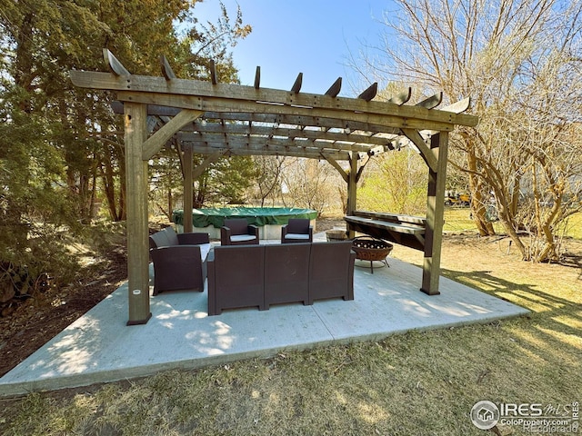 view of patio with an outdoor living space with a fire pit and a pergola