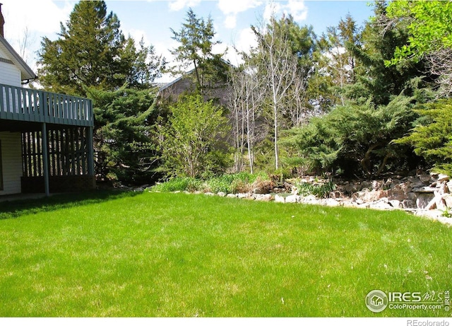 view of yard with a wooden deck
