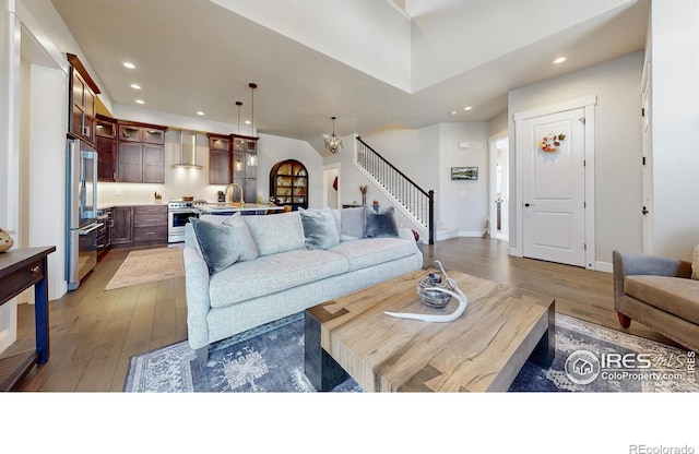 1563 Stoneseed St, Berthoud, CO 80513 - living area featuring wood-type flooring, baseboards, stairs, and recessed lighting