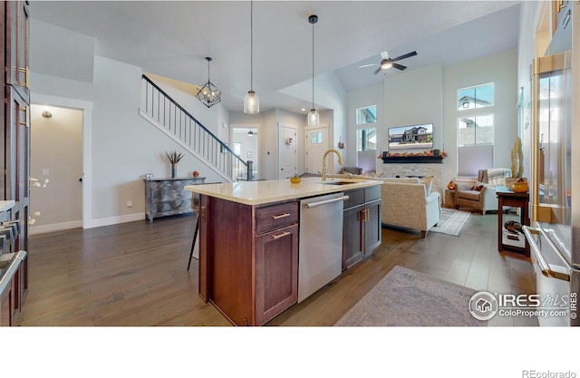 1563 Stoneseed St, Berthoud, CO 80513 - kitchen featuring a sink, dark wood-style floors, open floor plan, stainless steel appliances, and ceiling fan