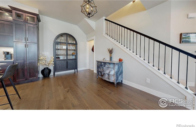 1563 Stoneseed St, Berthoud, CO 80513 - foyer entrance featuring baseboards, stairway, a chandelier, and wood finished floors