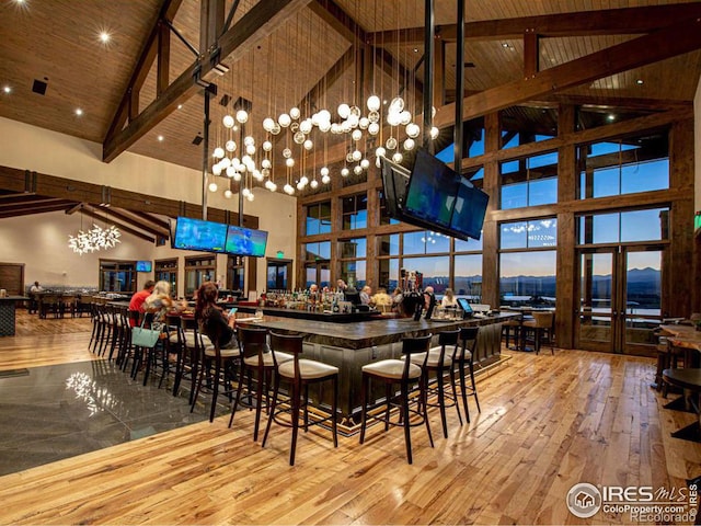 1563 Stoneseed St, Berthoud, CO 80513 - dining space featuring high vaulted ceiling, wood ceiling, french doors, hardwood / wood-style flooring, and beamed ceiling