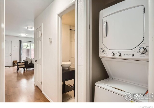 3790 Iris Ave Unit B, Boulder, CO 80301 - laundry room with stacked washing maching and dryer, laundry area, and light wood-type flooring